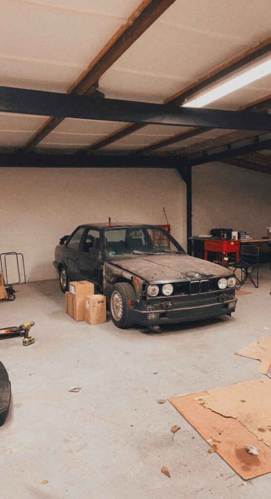 E30 with boxes of parts next to it